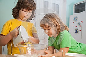 Happy family funny kids are preparing the dough, bake cookies in