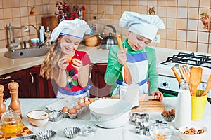 Happy family funny kids are preparing the dough, bake cookies in the kitchen