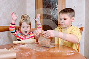 Happy family funny kids are preparing the dough, bake cookies in the kitchen