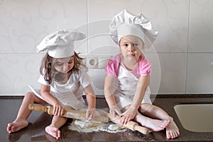 Happy family funny kids are preparing the dough, bake cookies in the kitchen