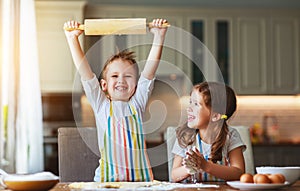 Happy family funny kids bake cookies in kitchen