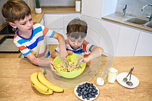 Happy family funny kids are preparing the dough, bake cookies in the kitchen