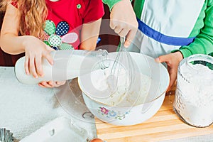 Happy family funny kids are preparing the dough, bake cookies in the kitchen