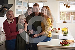 Happy family gathering in kitchen