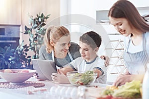 Happy family gathering together in kitchen