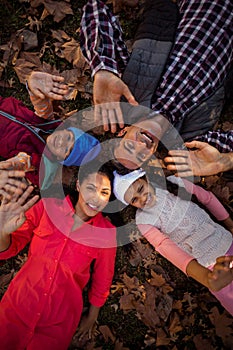 Happy family gesturing while forming huddle