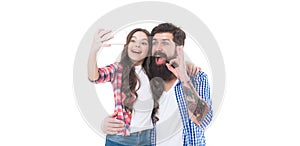 Happy family girl child and bearded man take selfie with mobile camera phone isolated on white, OK