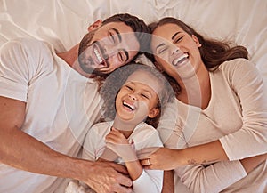 Happy family, girl and laughing parents having fun and spending quality time together at home from above. Portrait of