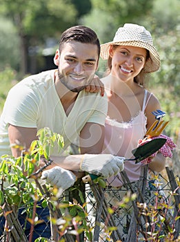 Happy family in gloves in garden