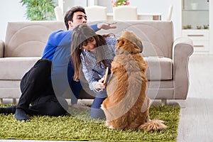 The happy family with golden retriever dog