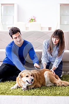 The happy family with golden retriever dog