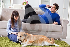 The happy family with golden retriever dog