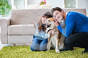 The happy family with golden retriever dog