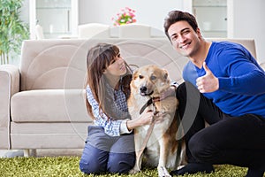 The happy family with golden retriever dog