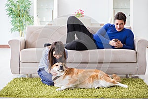 The happy family with golden retriever dog