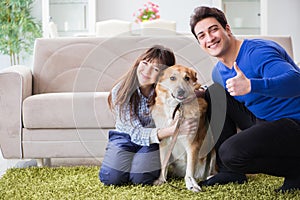 The happy family with golden retriever dog