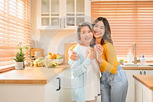 happy family grandmother with daughter portrait. cheerful family in kitchen smiling together.