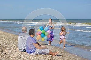 Happy family. Grandmother, grandfather and two joyful granddaughters.