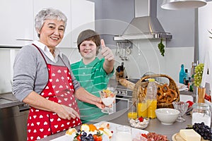 Happy family: Grandmother and grandson cooking together.