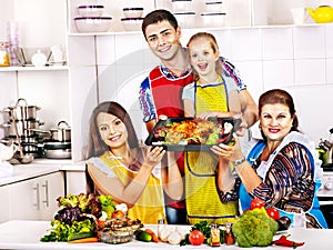 Happy family with grandmother at kitchen.