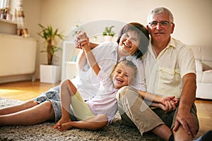 Happy family. Grandparents with granddaughter at home.