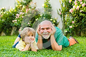 Happy family Grandson hugs his grandpa on holiday. Grandfather and grandson Playing - Family Time Together. Happy family