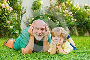 Happy family Grandson hugs his grandpa on holiday. Grandfather and grandson Playing - Family Time Together. Happy family