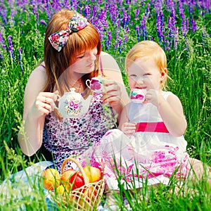 Happy Family in Green Grass take a Teaparty.