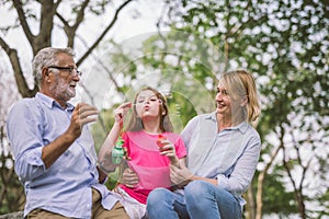 Happy family in green nature park on summer