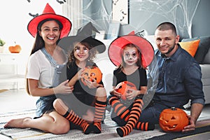 Happy family with Halloween candy buckets and pumpkin head jack lantern