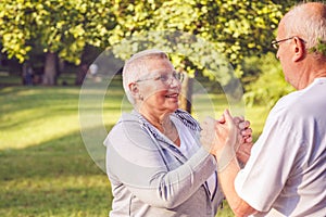 Happy family - Hands of senior couple during walk in park on sun