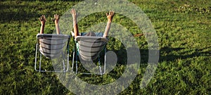 Happy family hands up in summer nature, mother and son relax outdoors