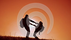 Happy family happy family teamwork business travel concept. couple silhouette holding hands are spinning with backpacks