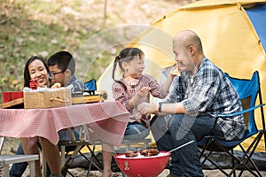 Happy family has father and mother, brother and sister asian having fun to camping in river in summer time with smile and laughing