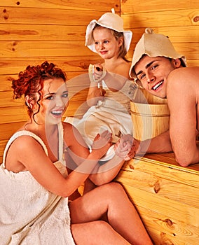 Happy family in hat at sauna