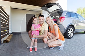 Happy family with hatchback car at home parking