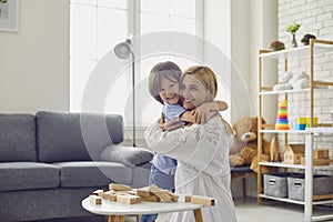Happy family have fun playing board games in the room. Mother and daughter hugging cute after playing at home