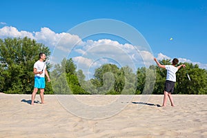 Happy family have fun on summer vacation. Sports games on the beach. Active healthy lifestyle concept