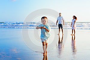 Happy family have fun on sunset beach