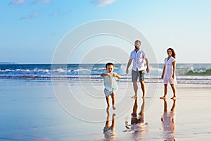 Happy family have fun on sunset beach