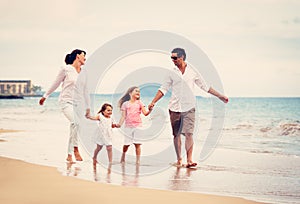 Happy Family have Fun Walking on Beach at Sunset