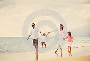 Happy Family have Fun Walking on Beach at Sunset