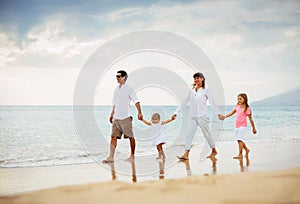 Happy Family have Fun Walking on Beach at Sunset