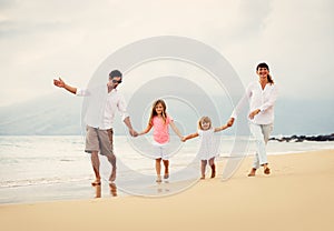 Happy Family have Fun Walking on Beach at Sunset