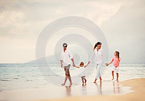 Happy Family have Fun Walking on Beach at Sunset