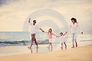 Happy Family have Fun Walking on Beach at Sunset