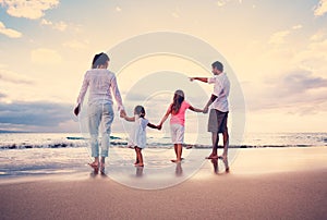 Happy Family have Fun Walking on Beach at Sunset