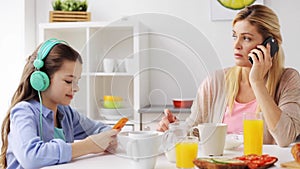 Happy family having breakfast at home kitchen