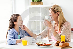 Happy family having breakfast at home kitchen