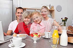 Happy family having breakfast together